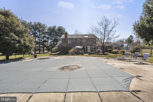 view of swimming pool featuring a patio area, fence, and a fenced in pool