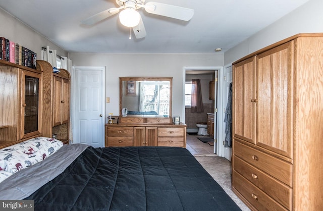 bedroom with ensuite bath, ceiling fan, and carpet floors