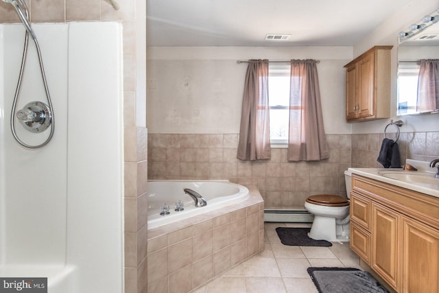 bathroom with vanity, a garden tub, tile patterned floors, tile walls, and baseboard heating