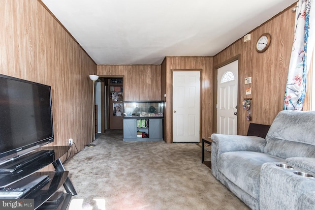 living room with light colored carpet and wood walls