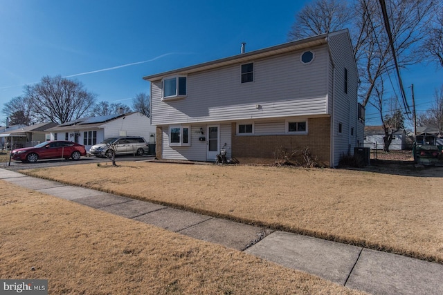 view of front of house with brick siding and a front yard