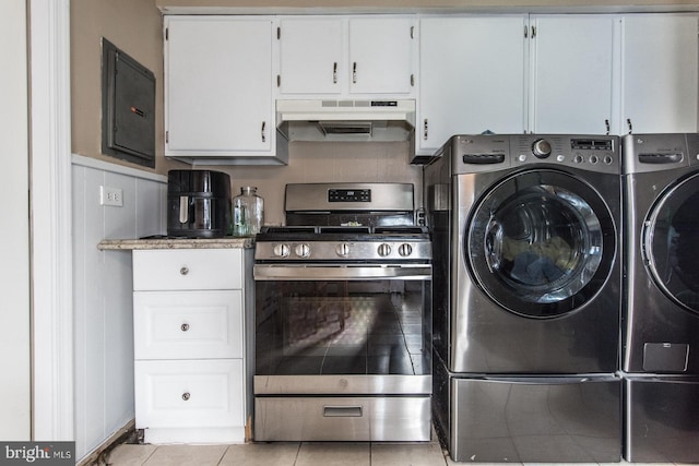 interior space featuring electric panel, light tile patterned floors, laundry area, and separate washer and dryer