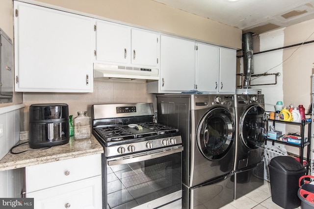 laundry room featuring laundry area, light tile patterned floors, and washing machine and dryer