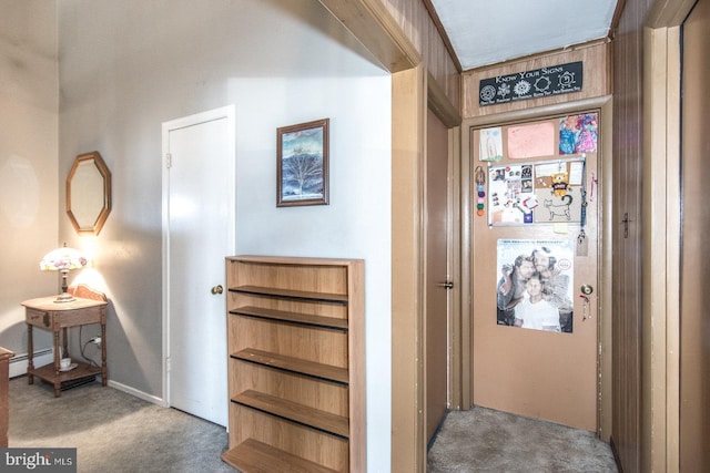 hallway featuring baseboard heating and carpet