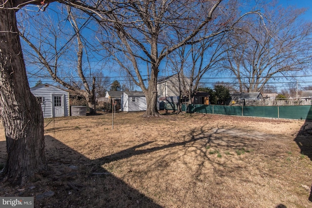 view of yard with a storage unit, an outdoor structure, and fence