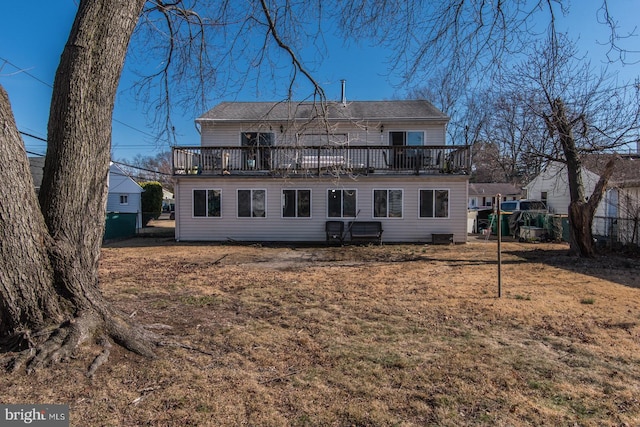 back of house featuring a wooden deck and fence