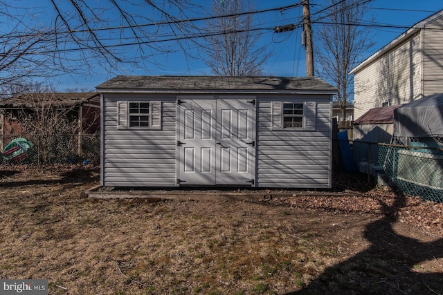 view of shed with fence