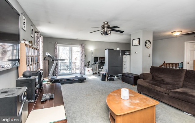 carpeted living room with ceiling fan