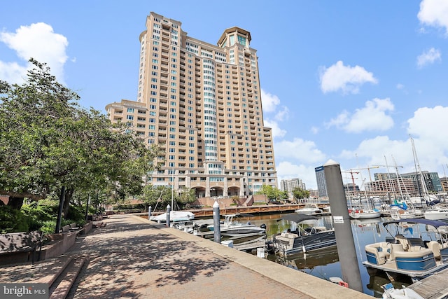 dock area featuring a water view and a view of city