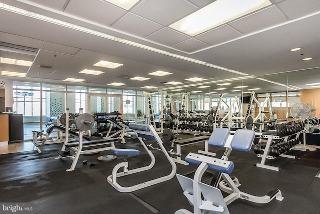 workout area featuring visible vents and a paneled ceiling