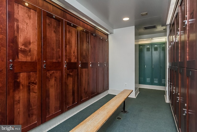 mudroom with baseboards, visible vents, and dark carpet