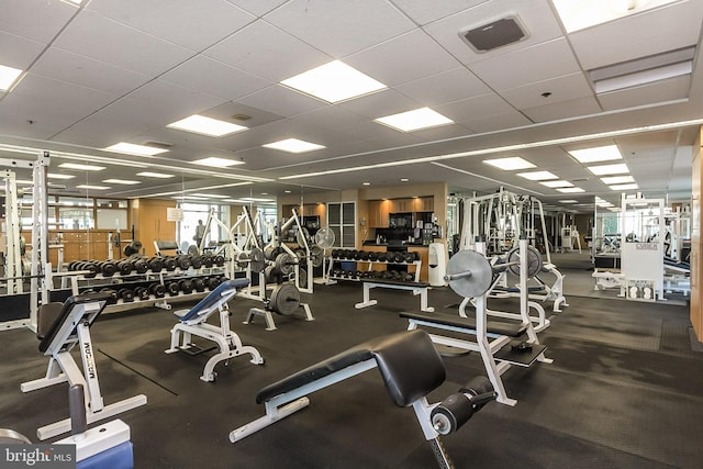 exercise room featuring a wealth of natural light, visible vents, and a paneled ceiling