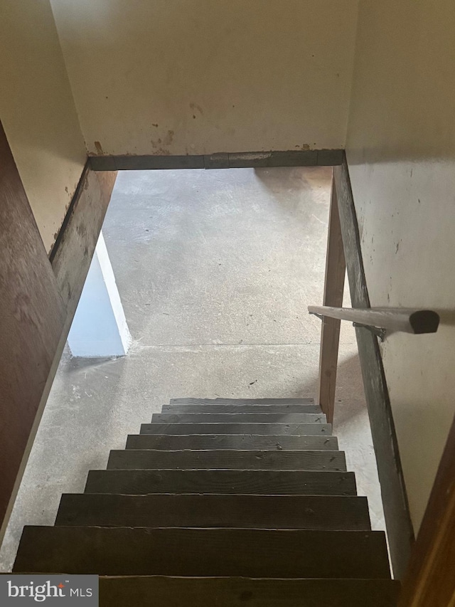 stairway with concrete flooring