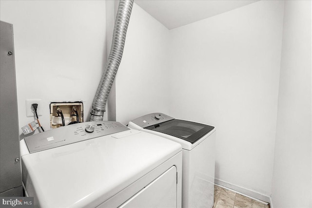 laundry area with washing machine and clothes dryer, laundry area, marble finish floor, and baseboards