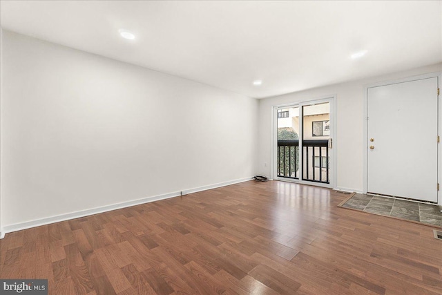 foyer entrance featuring wood finished floors and baseboards