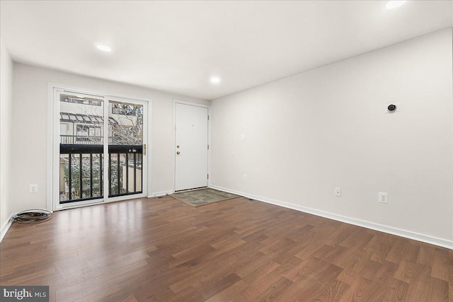 empty room with baseboards and wood finished floors