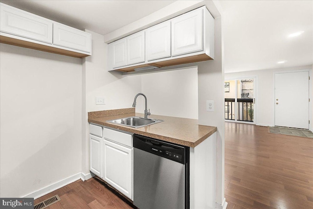 kitchen featuring dishwasher, dark wood finished floors, visible vents, and a sink