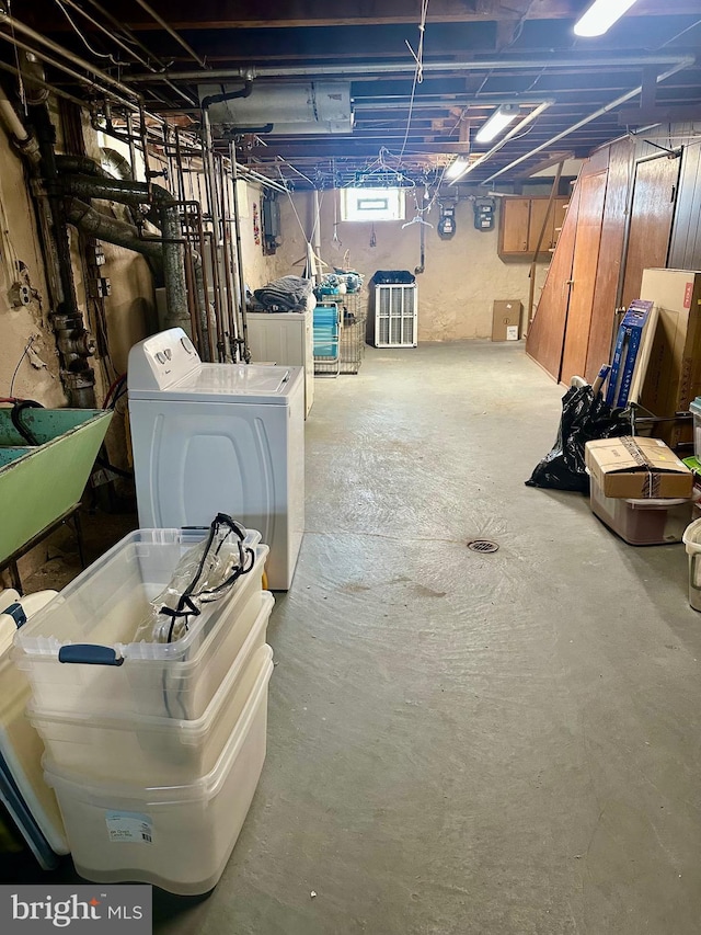 basement featuring independent washer and dryer and a sink