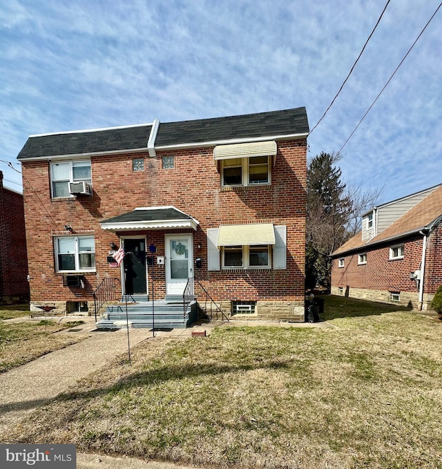 view of front of property featuring brick siding and a front yard