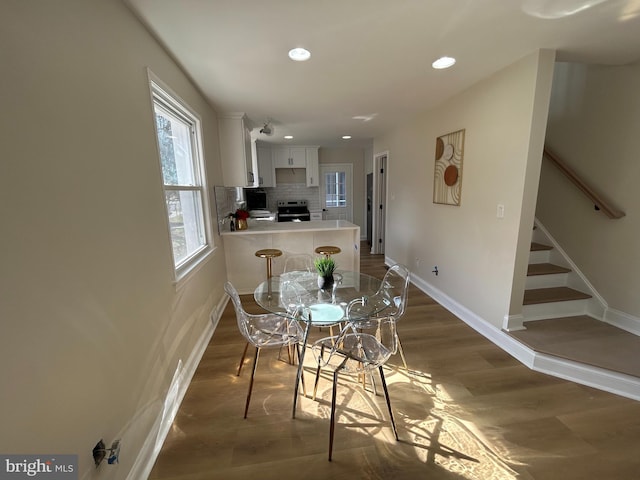 dining room featuring recessed lighting, stairway, baseboards, and dark wood-style floors