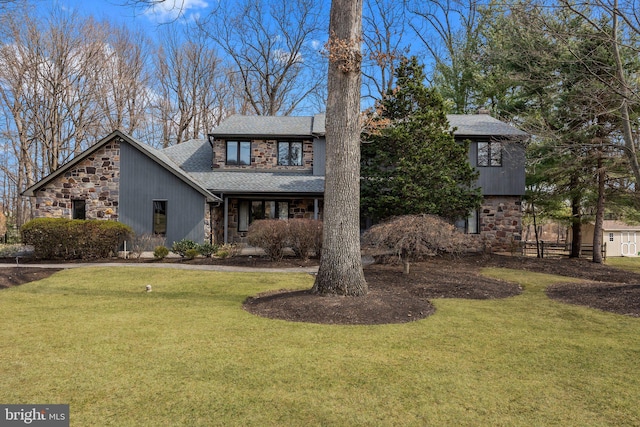 view of front of house featuring stone siding, roof with shingles, and a front lawn