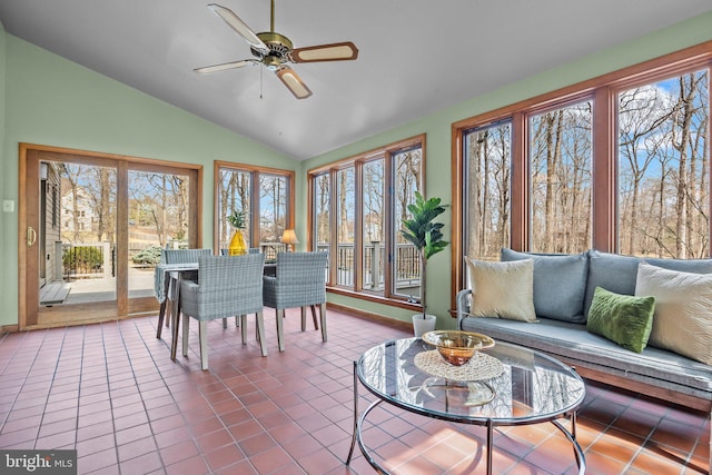 sunroom with ceiling fan and vaulted ceiling