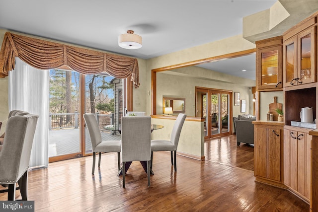 dining area with hardwood / wood-style floors, french doors, and a wealth of natural light