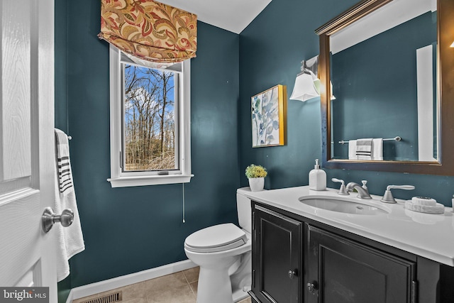 half bathroom with tile patterned floors, baseboards, toilet, and a wealth of natural light