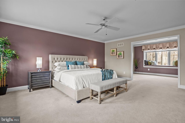 carpeted bedroom with visible vents, ceiling fan, baseboards, and ornamental molding