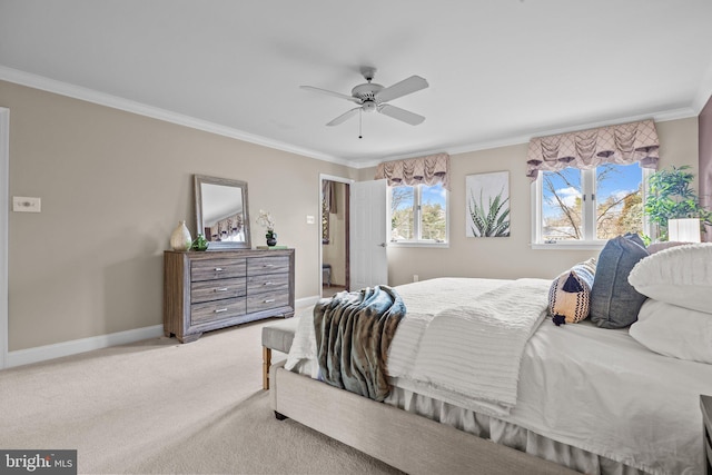 carpeted bedroom with baseboards, ornamental molding, and a ceiling fan