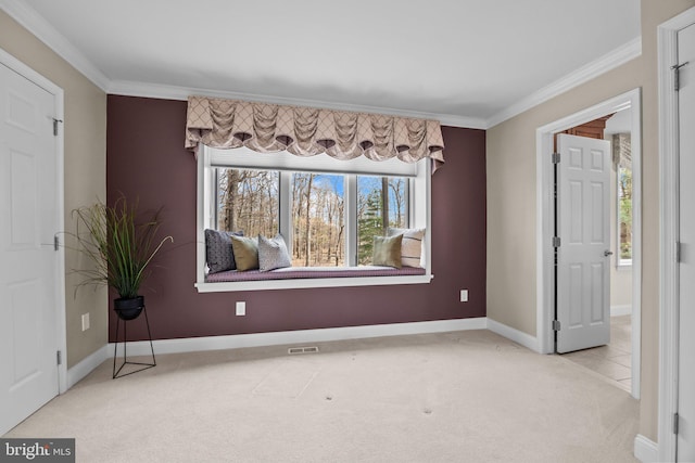 carpeted empty room with crown molding, baseboards, and visible vents