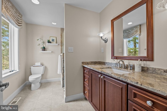 bathroom with vanity, visible vents, baseboards, tile patterned flooring, and toilet