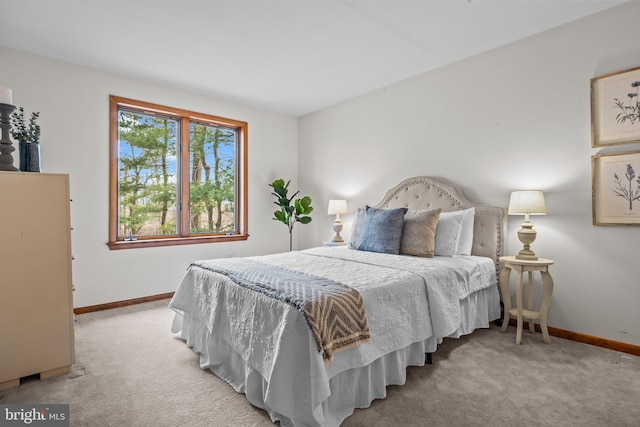 bedroom featuring baseboards and light carpet