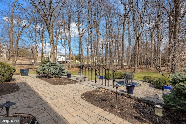 view of patio featuring fence