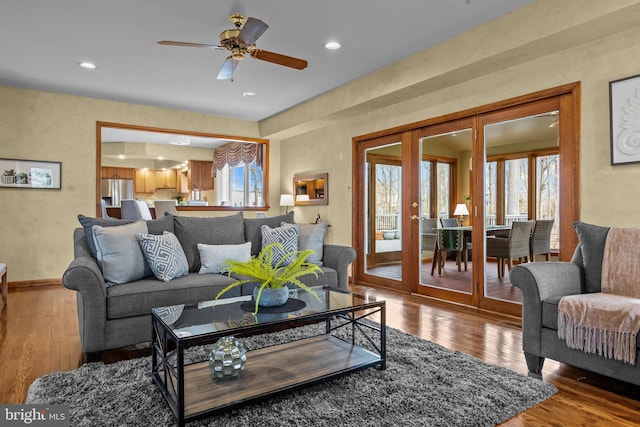 living area featuring hardwood / wood-style flooring, recessed lighting, french doors, and ceiling fan