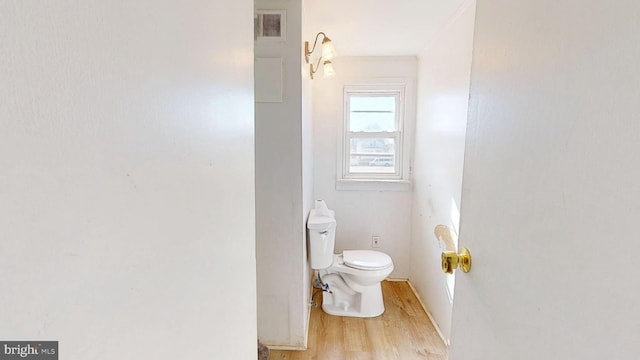 bathroom with visible vents, toilet, and wood finished floors