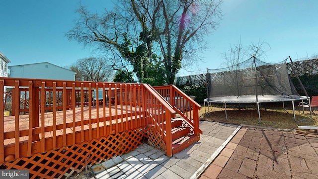 wooden terrace with a trampoline