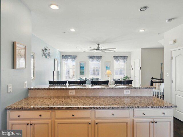 kitchen with light stone counters, a healthy amount of sunlight, ceiling fan, and recessed lighting