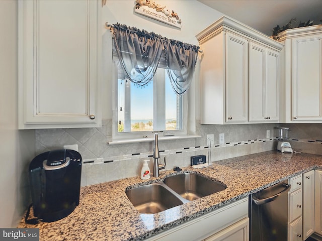 kitchen featuring a sink, decorative backsplash, and stainless steel dishwasher