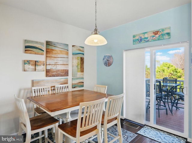 dining space featuring baseboards and wood finished floors