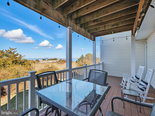 wooden terrace featuring outdoor dining space