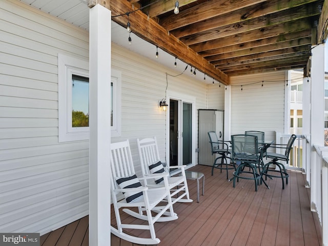 deck with outdoor dining area