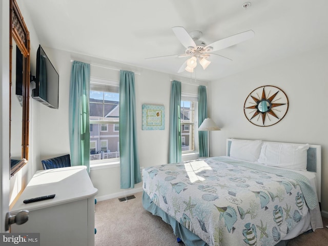 bedroom with visible vents, multiple windows, carpet, and ceiling fan