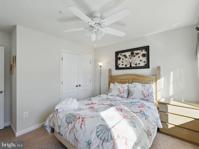 bedroom with a closet, carpet flooring, a ceiling fan, and baseboards