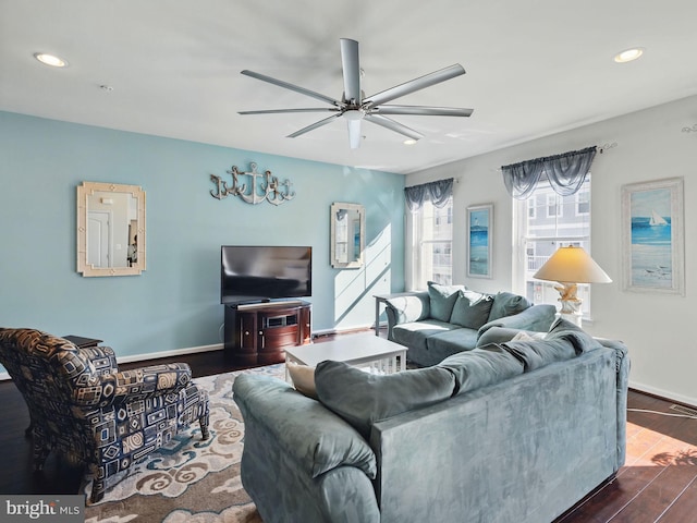 living area featuring recessed lighting, baseboards, and dark wood finished floors