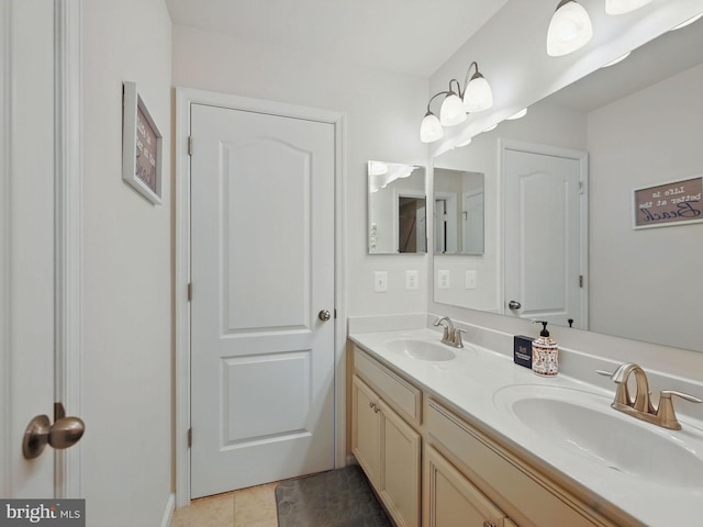 bathroom with double vanity, tile patterned floors, and a sink