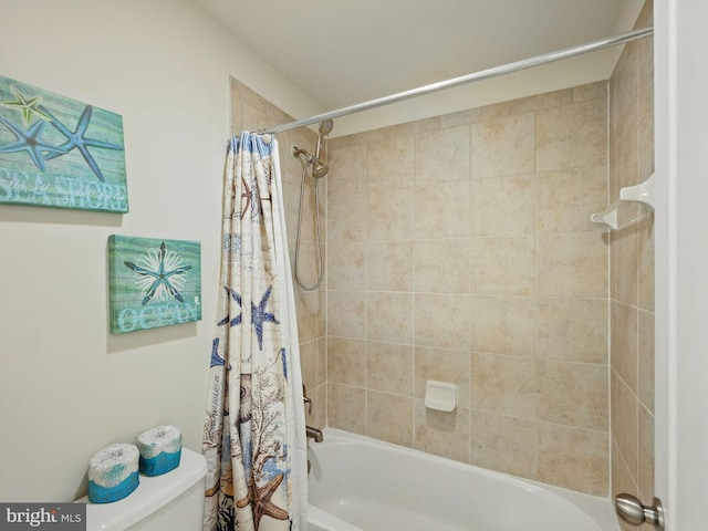 bathroom with shower / tub combo and toilet