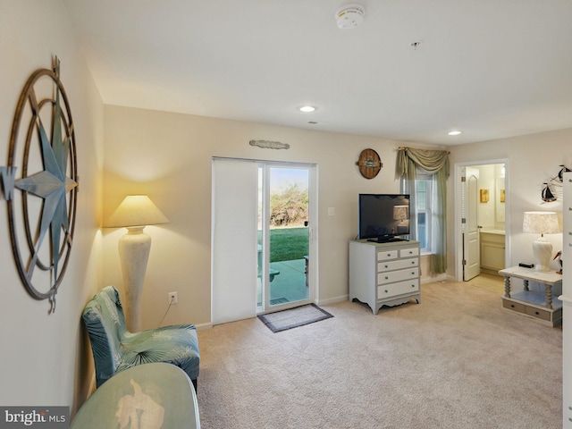 living room with recessed lighting, baseboards, and light carpet