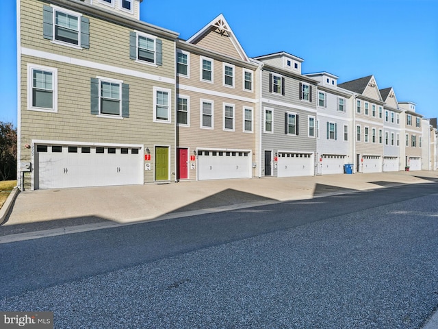 view of property featuring a residential view and an attached garage