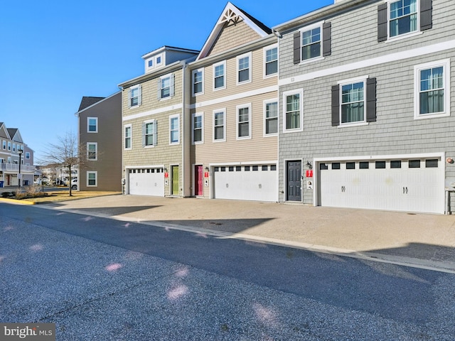 view of property featuring a garage and a residential view